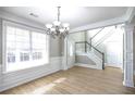 Bright dining room with hardwood floors and chandelier at 1444 Tether Ln, Mcdonough, GA 30253