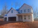 Unfinished two-story home showing the framework, siding, and windows, ready for customization at 6945 Melody Dr, Buford, GA 30518