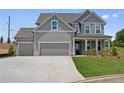 Beautiful two-story home featuring a three-car garage and a well-manicured lawn at 6945 Melody Dr, Buford, GA 30518