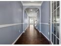 Bright entryway with hardwood floors, neutral walls, and an arched passage at 7633 Summer Berry Ln, Lithonia, GA 30038