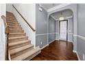 Carpeted staircase with wooden railing in a two-story home at 7633 Summer Berry Ln, Lithonia, GA 30038