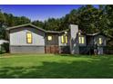 Charming single-Gathering home featuring a well-manicured lawn and unique architectural elements at 2784 Sixes Rd, Canton, GA 30114