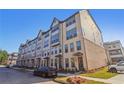 Modern townhome featuring a brick facade, multiple stories, and well-maintained landscaping at 3879 Allegretto Cir # 116, Atlanta, GA 30339