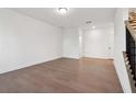 Spacious, bright living room with hardwood floors and fresh, white walls at 3879 Allegretto Cir # 116, Atlanta, GA 30339