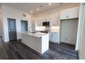 Modern kitchen with white cabinets, island, and stainless steel appliances at 556 Sawnee Village Blvd # D76, Cumming, GA 30040