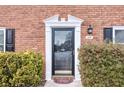 Charming brick home showcases a black front door with decorative white trim and manicured landscaping at 4195 Jeanette Ct, Norcross, GA 30093