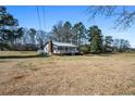 Wide shot of the cozy home and its generous, well-maintained lot at 5333 Pine Valley Rd, Powder Springs, GA 30127