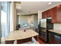 Granite kitchen island and stainless steel appliances with city views at 855 Peachtree Ne St # 2412, Atlanta, GA 30308