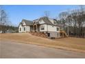 Stunning two-story home showcasing a side view and backyard at 325 Mont Harmony Sw Rd, Powder Springs, GA 30127