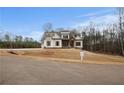 Two-story home with a welcoming front porch and mature trees at 325 Mont Harmony Sw Rd, Powder Springs, GA 30127