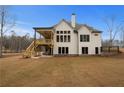 Home's back view featuring a large deck and backyard at 325 Mont Harmony Sw Rd, Powder Springs, GA 30127