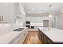 Modern kitchen featuring stainless steel appliances, white cabinetry and hardwood floors at 325 Mont Harmony Sw Rd, Powder Springs, GA 30127