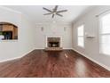 Open living room features hardwood floors, fireplace, ceiling fan, and natural light at 1019 Walnut Creek Dr, Woodstock, GA 30188