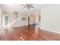 Bright living room features hardwood floors, stairs, archway, and natural light at 1019 Walnut Creek Dr, Woodstock, GA 30188