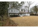 Gray house with white trim, steps and a two-car garage at 1472 Silver Maple Sw Ct, Lilburn, GA 30047