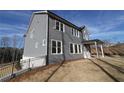 Backyard view of home with covered porch and privacy fence at 1975 Sage Lake Bend Sw, Marietta, GA 30064