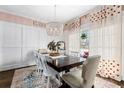 Elegant dining room with a large table, chandelier, and stylish curtains at 370 Park Ne Pl, Atlanta, GA 30317