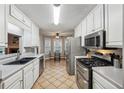 Kitchen with white cabinets, stainless steel appliances, and tile floor at 3525 W River Commons, Douglasville, GA 30135