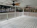 Spacious covered deck featuring two ceiling fans and white railing, perfect for outdoor relaxation at 3967 Evelyn Dr, Powder Springs, GA 30127