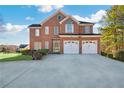 Elegant brick home featuring a two-car garage and manicured landscaping at 1268 Windsor Glen Dr, Douglasville, GA 30134