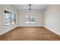 Inviting dining room with natural light, hardwood flooring, and a contemporary light fixture at 125 Drummond Pl, Covington, GA 30014