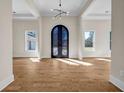 Elegant entryway with a decorative wrought iron front door and gleaming wood floors at 125 Drummond Pl, Covington, GA 30014