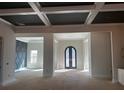 Bright, spacious living room featuring a stylish coffered ceiling, modern lighting, and an open layout at 125 Drummond Pl, Covington, GA 30014