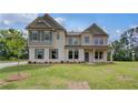 Attractive two-story house boasts detailed trim and shuttered windows at 157 Haverling Pass, Hampton, GA 30228