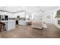 Open-concept living room featuring hardwood floors and a seamless transition into the kitchen area at 3211 Orwell Way # 4302, Cumming, GA 30041