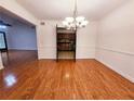 Bright dining room with hardwood floors and modern chandelier, adjacent to the kitchen at 1409 Oakridge Cir, Decatur, GA 30033