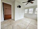 Bright sun room featuring tiled floor, wainscoting, and several windows to let in natural light at 1409 Oakridge Cir, Decatur, GA 30033