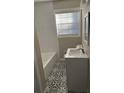 Updated bathroom with subway tile shower and patterned floor at 5380 Saint Lo Ln, Atlanta, GA 30349