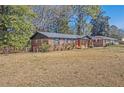 Charming red brick home with a well-maintained lawn and a carport with lawn extending to neighborhood at 5380 Saint Lo Ln, Atlanta, GA 30349