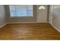 Bright living room with hardwood floors and large window at 5380 Saint Lo Ln, Atlanta, GA 30349