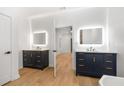 Spa-like bathroom with double vanity, a large mirror, and dark blue cabinets at 1835 W Taylor Ave, East Point, GA 30344