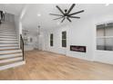 Light-filled living room with hardwood floors, fireplace, and modern ceiling fan at 1835 W Taylor Ave, East Point, GA 30344