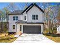 Charming two-story modern farmhouse with white siding, black trim, and a two-car garage at 101 Azalea Dr, Villa Rica, GA 30180