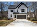 Charming two-story modern farmhouse with white siding, black trim, and a two-car garage at 101 Azalea Dr, Villa Rica, GA 30180
