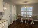 Charming dining area with wood table and chairs, hardwood floors at 945 Navajo Trl, Covington, GA 30016