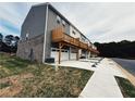 Townhomes featuring two-car garages, private decks, and modern architectural details, showcasing the community's appeal at 989 Cades Walk, Lawrenceville, GA 30045