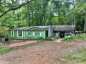 Charming single-Gathering home with an inviting covered porch set on a spacious lot surrounded by lush greenery at 202 Hayes St, Villa Rica, GA 30180