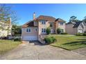 Charming two-story home with a well-manicured lawn, driveway and attached two-car garage at 3634 Autumn Ridge Pkwy, Marietta, GA 30066