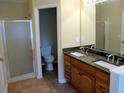 Bathroom featuring a granite countertop, double vanity, and glass shower at 959 Romer Pl, Stone Mountain, GA 30083