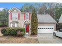 Inviting two-story home with red shutters and door, plus a two-car garage at 113 Ambridge Ct, Lawrenceville, GA 30044