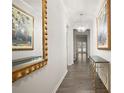 Bright entryway with hardwood floors, gold mirror, and a console table at 108 Berwick Xing, Dallas, GA 30157