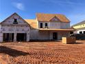 Exterior view of a new home in the framing stage with a two-car garage at 1949 Pucketts Sw Dr, Lilburn, GA 30047