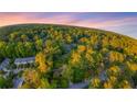 Beautiful aerial scene highlighting a cozy home surrounded by a lush, green forest landscape at 3293 Valleydale Sw Dr, Atlanta, GA 30311
