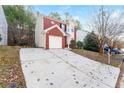 Front view of house, long driveway, and mature trees at 7077 Ravenwood Ln, Lithonia, GA 30038