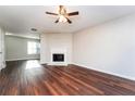 Living room with fireplace and wood-look flooring at 7077 Ravenwood Ln, Lithonia, GA 30038