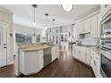 Bright kitchen featuring white cabinets, stainless steel appliances, and granite countertops at 5975 Deerwoods Trl, Alpharetta, GA 30005